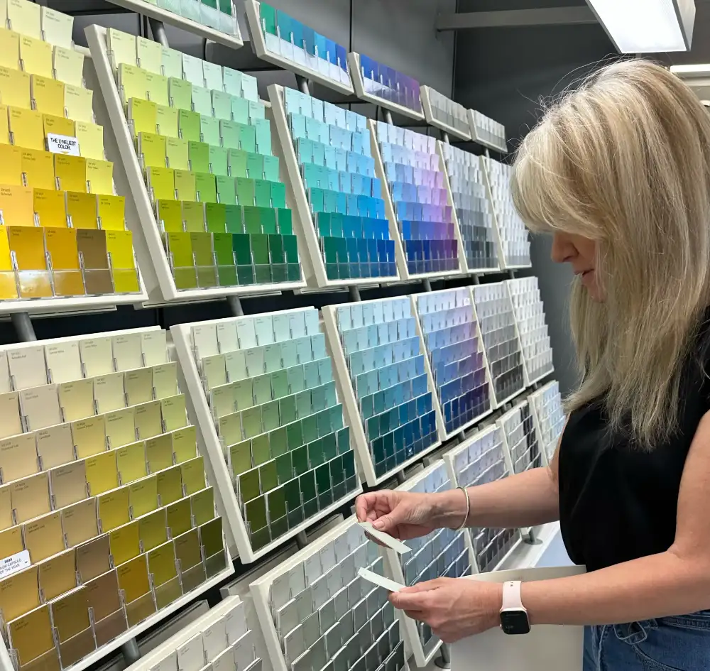 Photo image of Kristianne Stewart selecting paint colors for client.